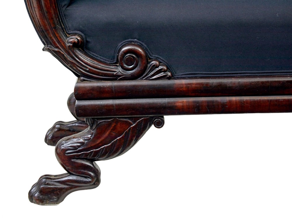 A 19th-century William IV mahogany chaise longue with hand-carved scroll detailing and dark fabric upholstery. View VII