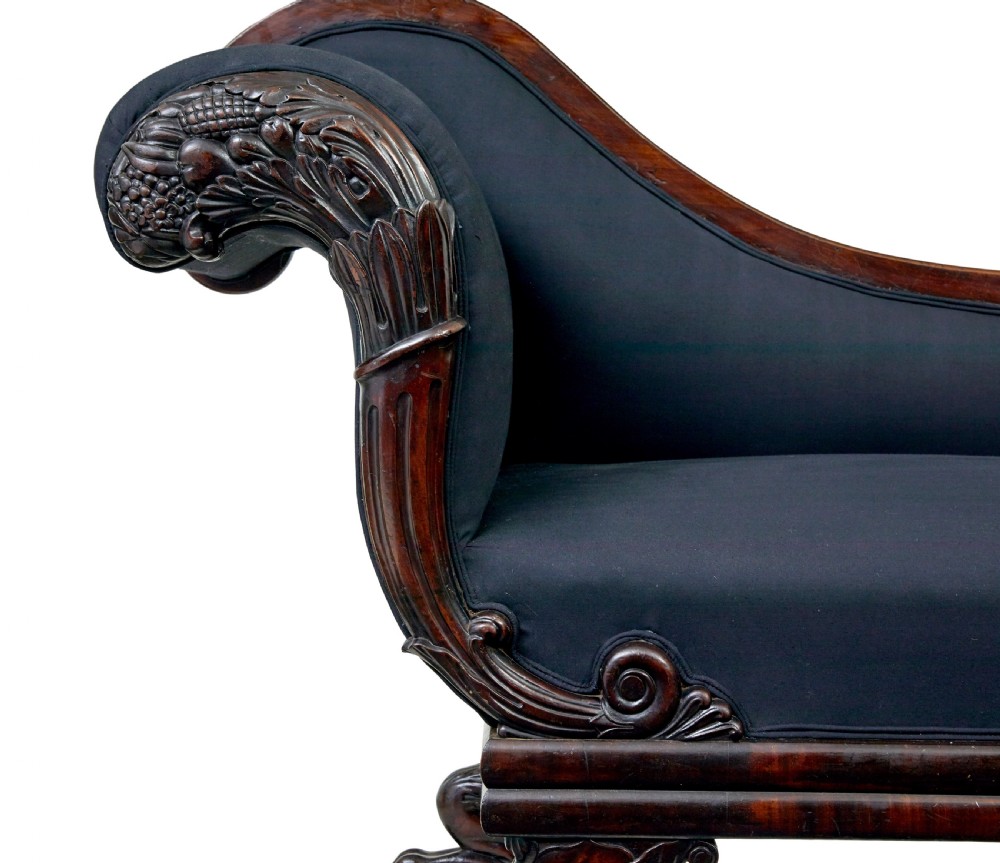 A 19th-century William IV mahogany chaise longue with hand-carved scroll detailing and dark fabric upholstery. View VIII