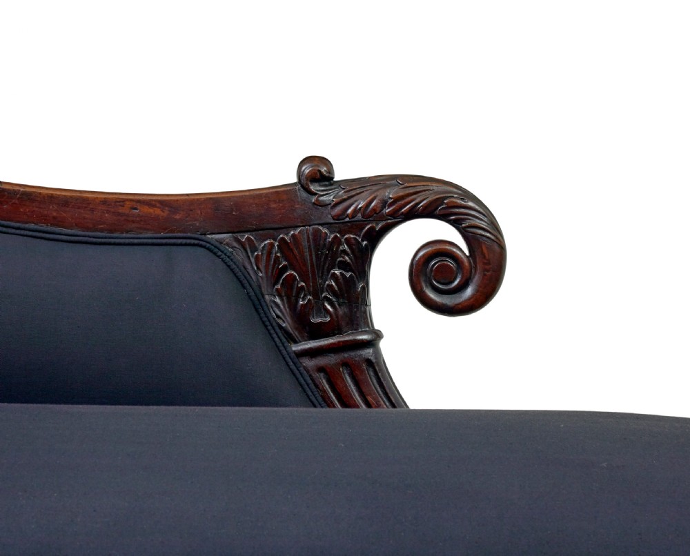 A 19th-century William IV mahogany chaise longue with hand-carved scroll detailing and dark fabric upholstery. View IX