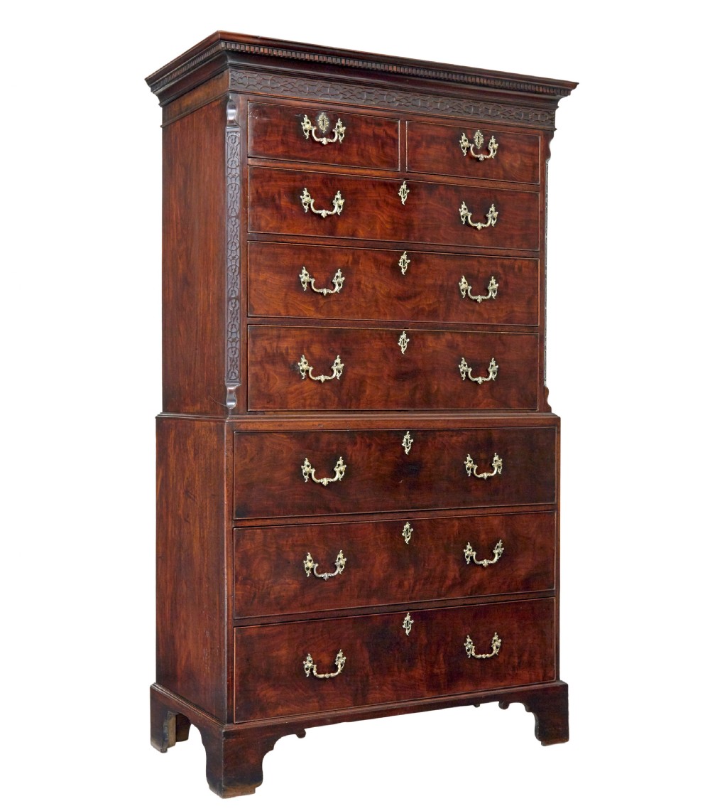 An early nineteenth-century Georgian mahogany chest on chest featuring bracket feet, brass swan-neck handles, and two stacked sections of graduated drawers.