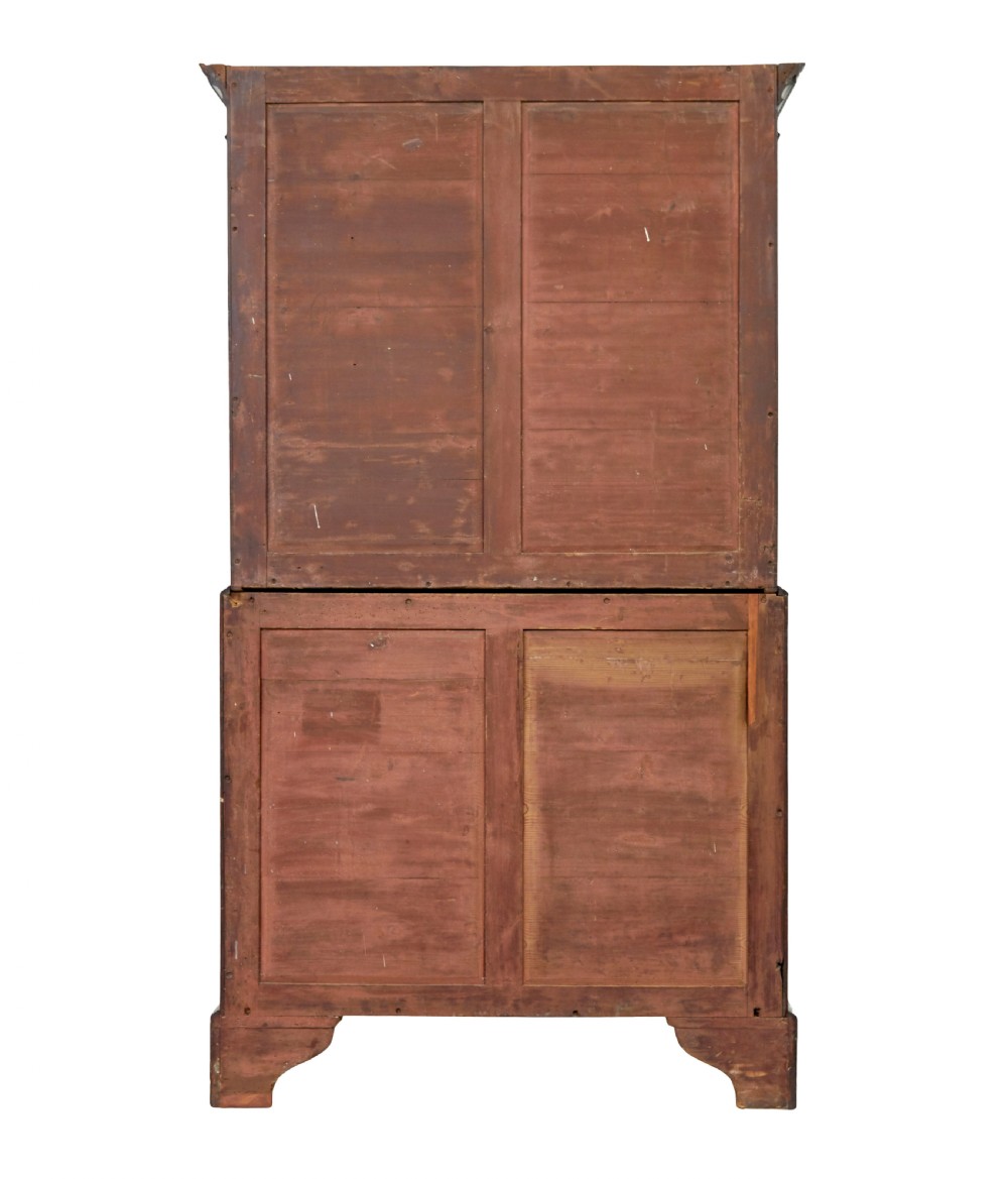 An early nineteenth-century Georgian mahogany chest on chest featuring bracket feet, brass swan-neck handles, and two stacked sections of graduated drawers. View VII