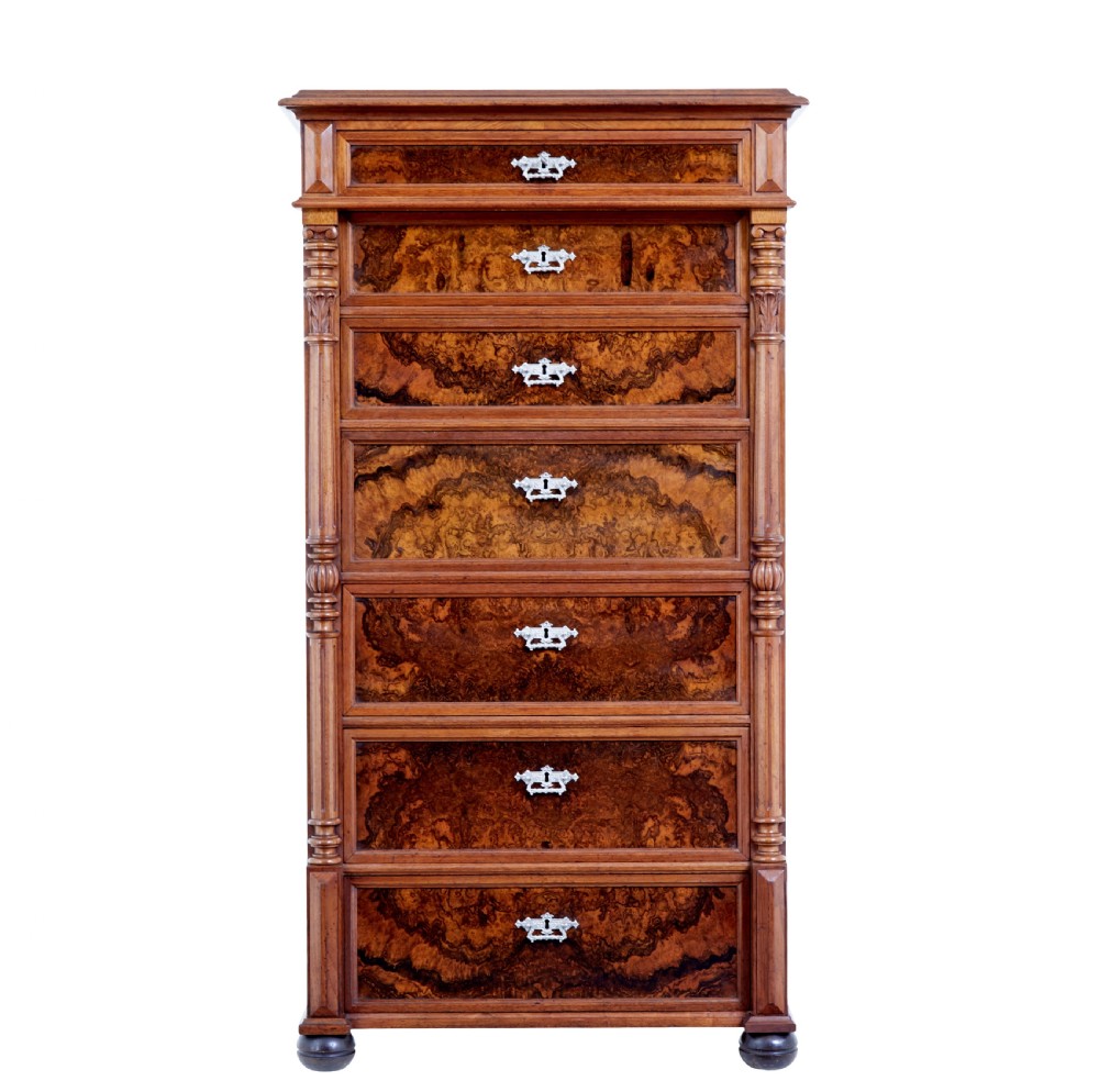 A tall 19th-century burr walnut secretaire chest of drawers featuring bookmatched veneer drawer fronts, fluted side columns, and ornate metal escutcheons.