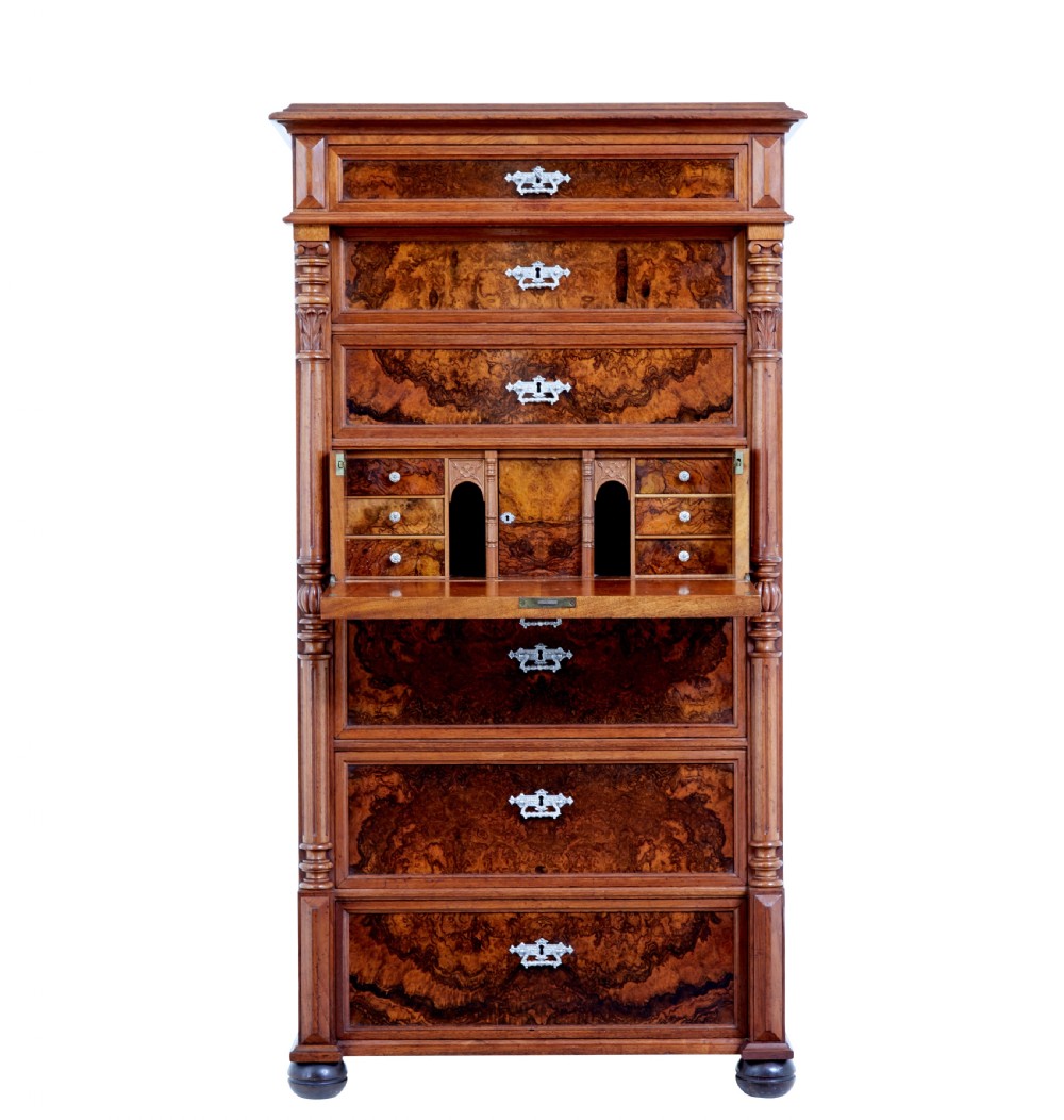 A tall 19th-century burr walnut secretaire chest of drawers featuring bookmatched veneer drawer fronts, fluted side columns, and ornate metal escutcheons. View II