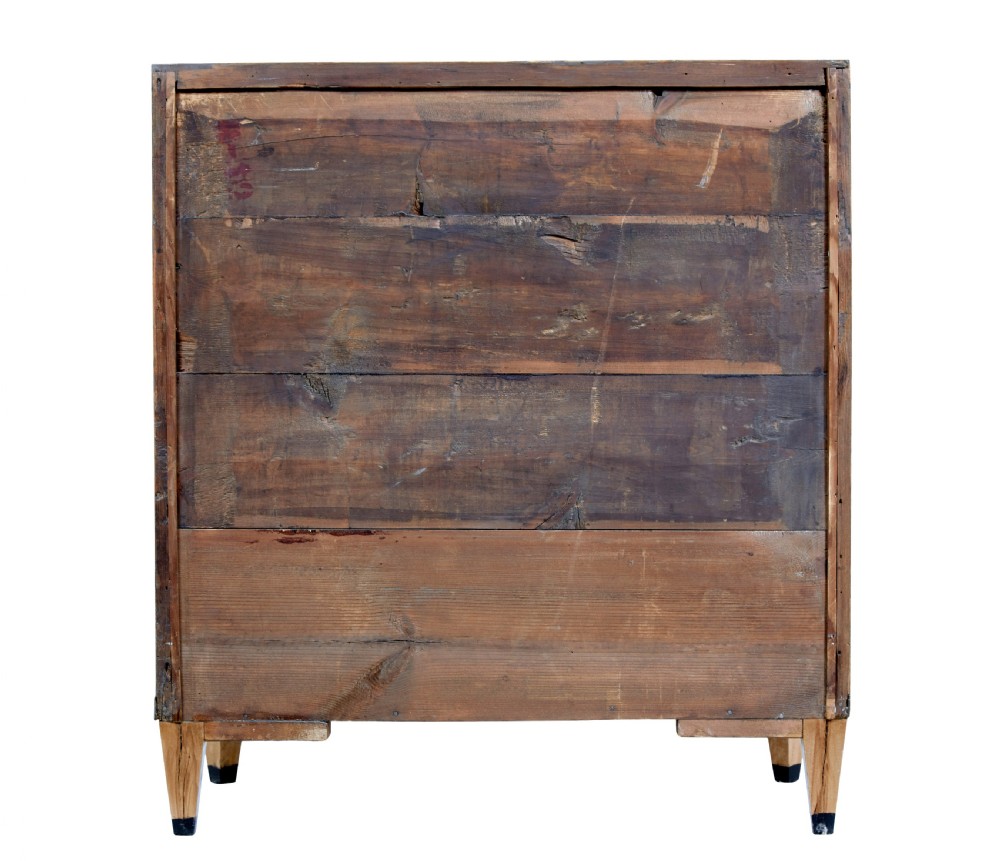 A 19th-century Swedish birch chest of drawers featuring three drawers, flame grain veneers, dark timber inlay, and brass keyhole escutcheons on tapered legs. View VII