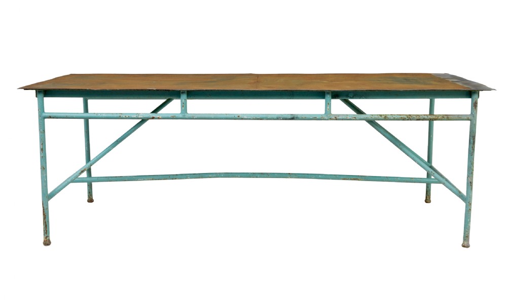 A large 1920s industrial table featuring a turquoise painted tubular steel frame with diagonal bracing and a flat rusty steel top. View IV