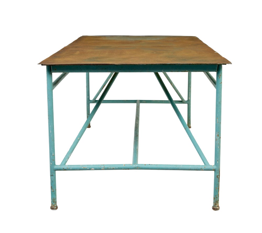 A large 1920s industrial table featuring a turquoise painted tubular steel frame with diagonal bracing and a flat rusty steel top. View V