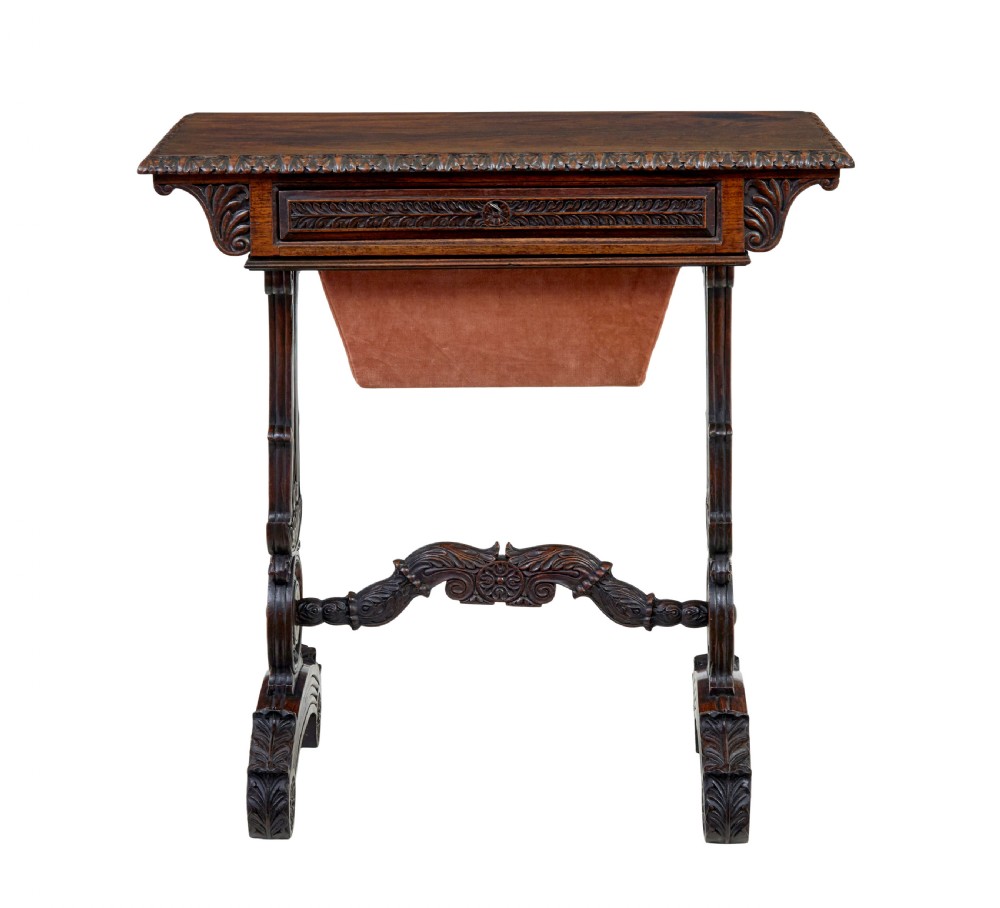 A 19th-century dark carved padouk wood side table featuring an integrated fabric work well and carved trestle legs. View VIII