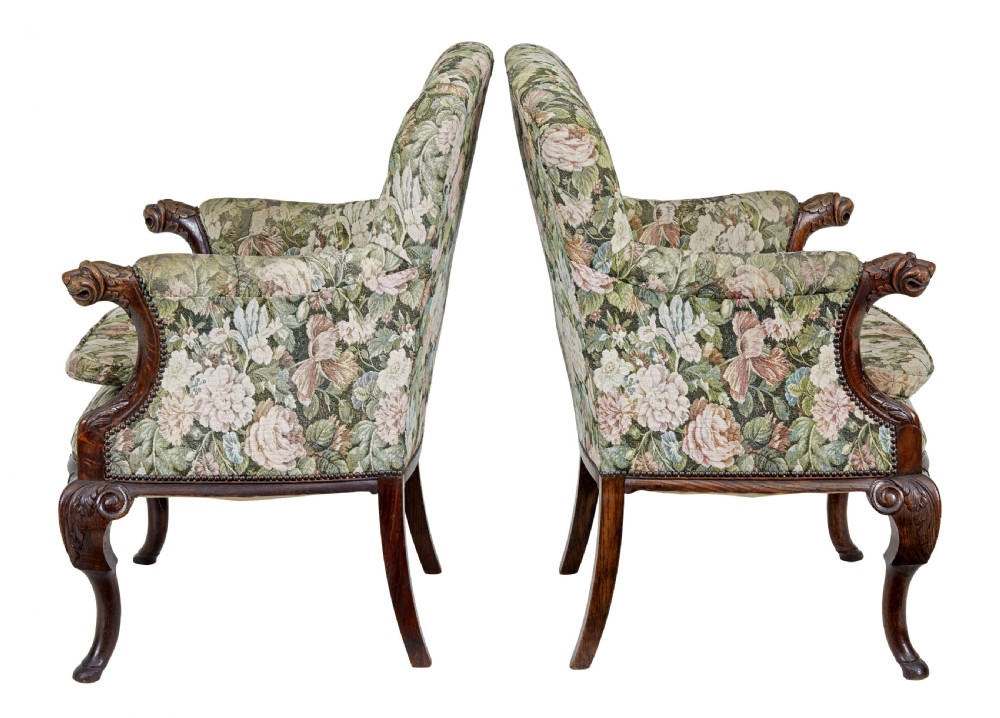 A pair of 19th-century French carved oak armchairs upholstered in a green floral tapestry fabric with carved lion-head armrests. View III