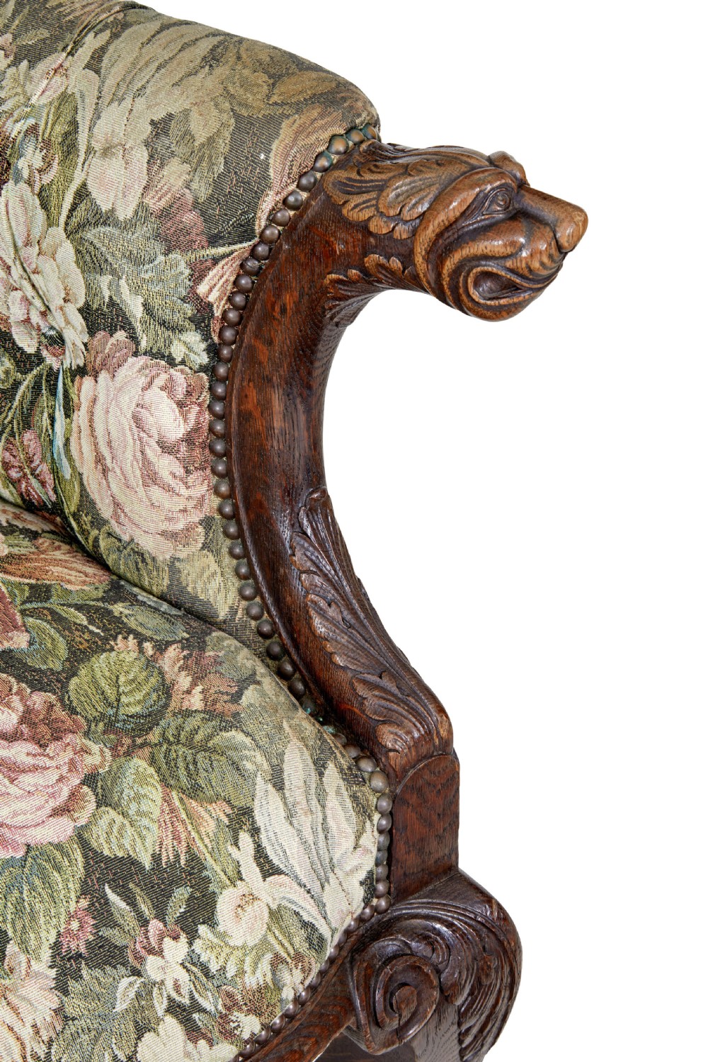 A pair of 19th-century French carved oak armchairs upholstered in a green floral tapestry fabric with carved lion-head armrests. View IX