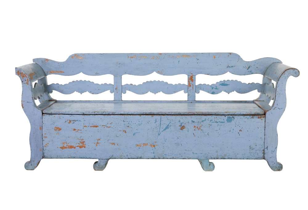 A mid 19th-century Swedish wooden storage bench featuring a distressed light blue painted finish, scalloped backrest rails, and flared armrests.