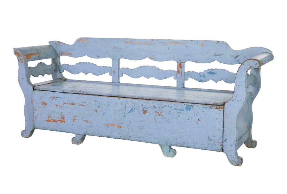 A mid 19th-century Swedish wooden storage bench featuring a distressed light blue painted finish, scalloped backrest rails, and flared armrests. View II