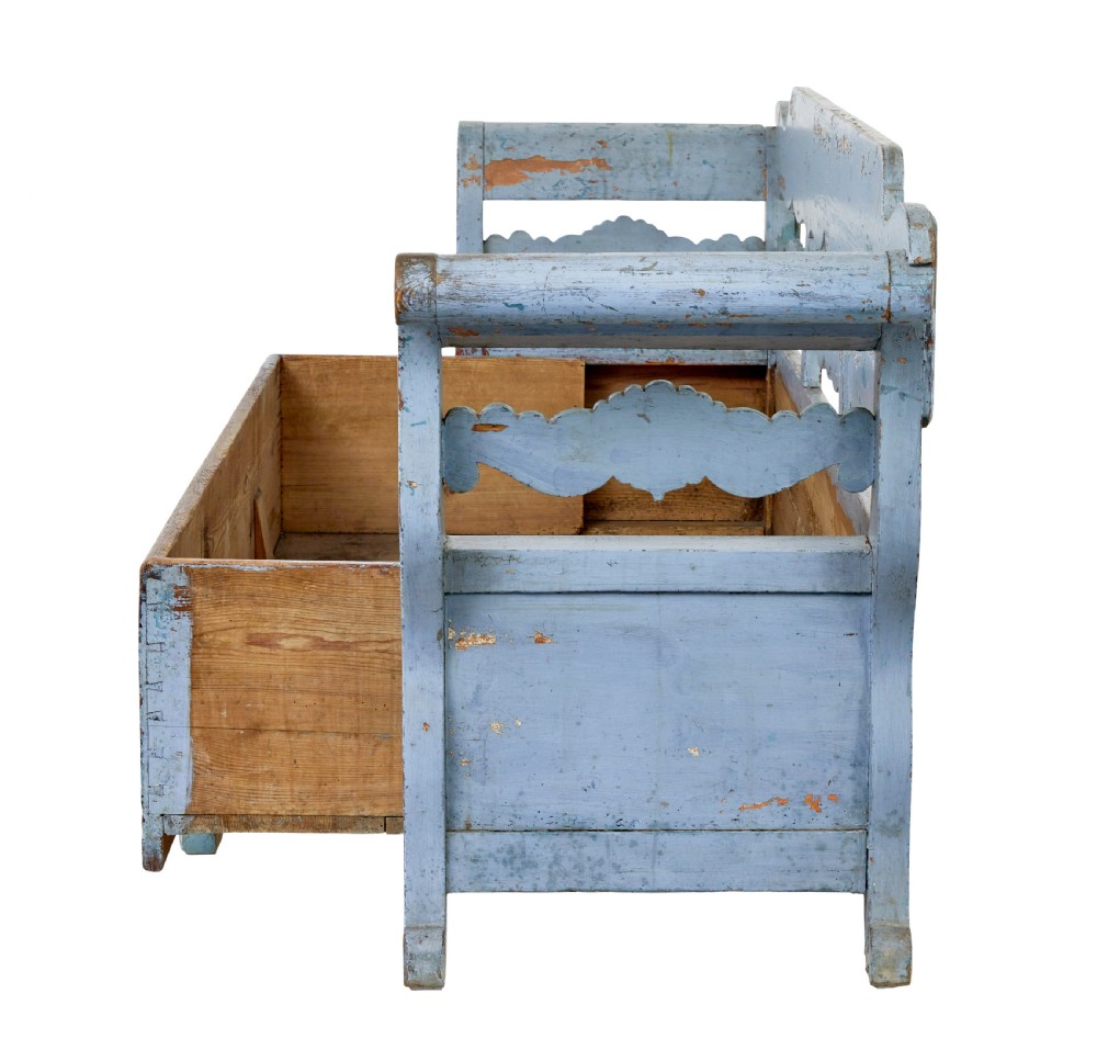 A mid 19th-century Swedish wooden storage bench featuring a distressed light blue painted finish, scalloped backrest rails, and flared armrests. View V