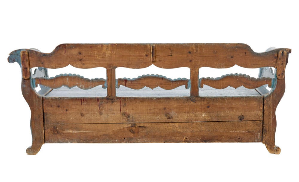 A mid 19th-century Swedish wooden storage bench featuring a distressed light blue painted finish, scalloped backrest rails, and flared armrests. View VI