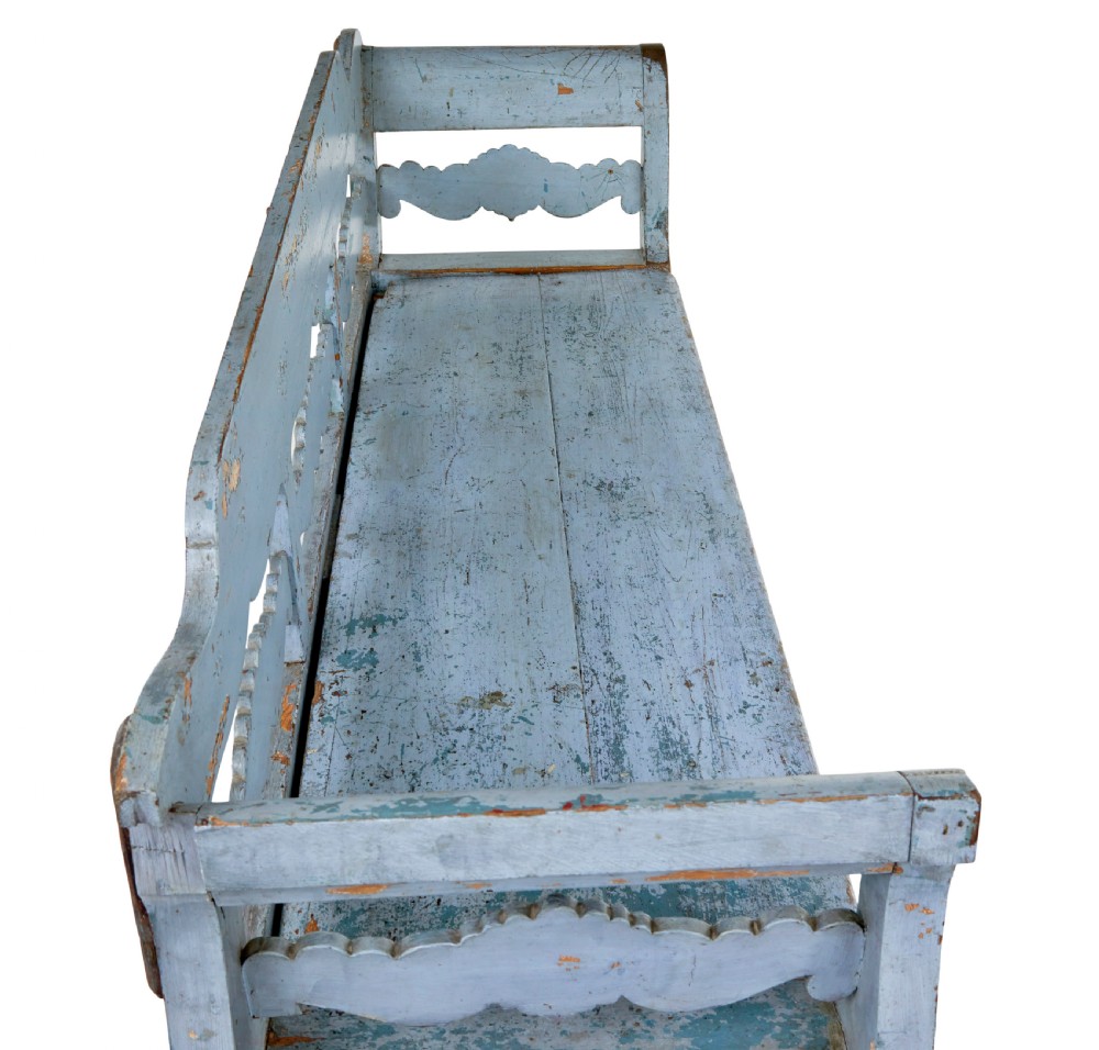 A mid 19th-century Swedish wooden storage bench featuring a distressed light blue painted finish, scalloped backrest rails, and flared armrests. View VIII