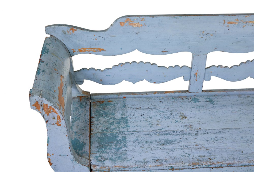 A mid 19th-century Swedish wooden storage bench featuring a distressed light blue painted finish, scalloped backrest rails, and flared armrests. View IX