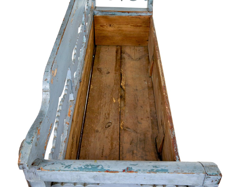 A mid 19th-century Swedish wooden storage bench featuring a distressed light blue painted finish, scalloped backrest rails, and flared armrests. View XI