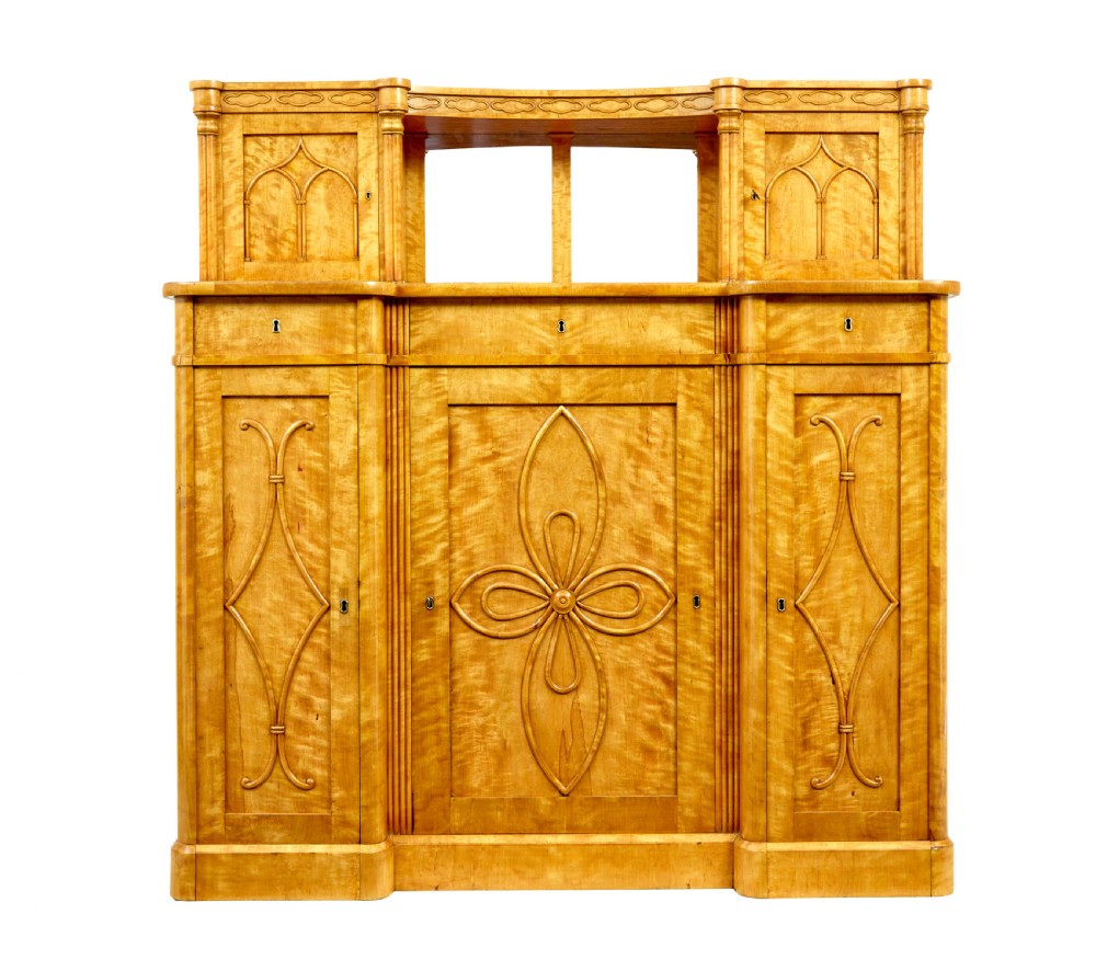 A mid-19th-century Swedish satin birch buffet sideboard featuring a lower three-door cabinet with carved petal applied mouldings and an upper tiered superstructure with Gothic arch cabinet doors. View II