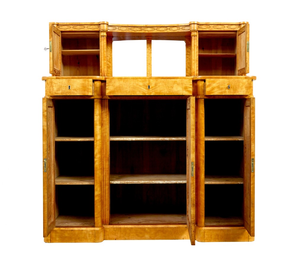 A mid-19th-century Swedish satin birch buffet sideboard featuring a lower three-door cabinet with carved petal applied mouldings and an upper tiered superstructure with Gothic arch cabinet doors. View III