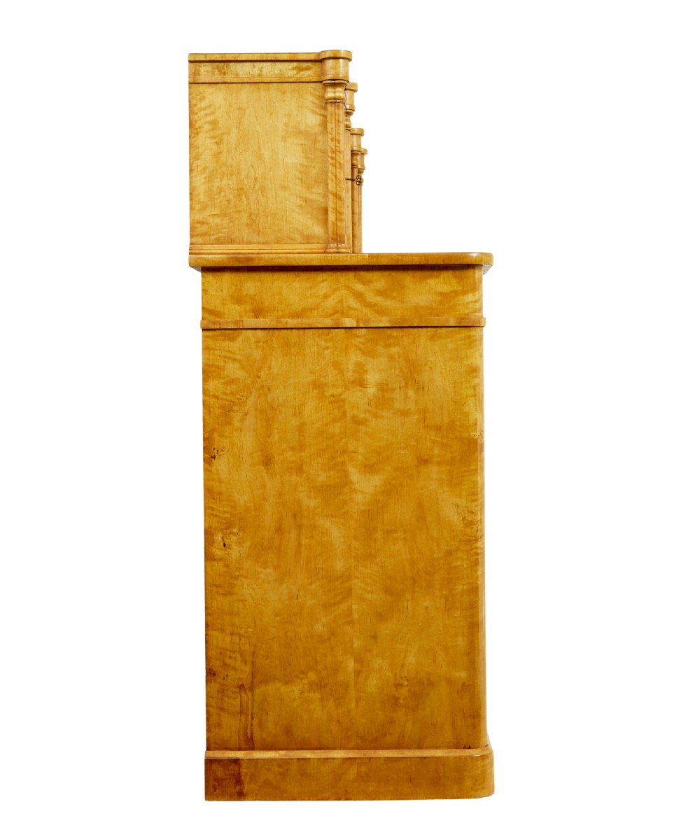 A mid-19th-century Swedish satin birch buffet sideboard featuring a lower three-door cabinet with carved petal applied mouldings and an upper tiered superstructure with Gothic arch cabinet doors. View IV