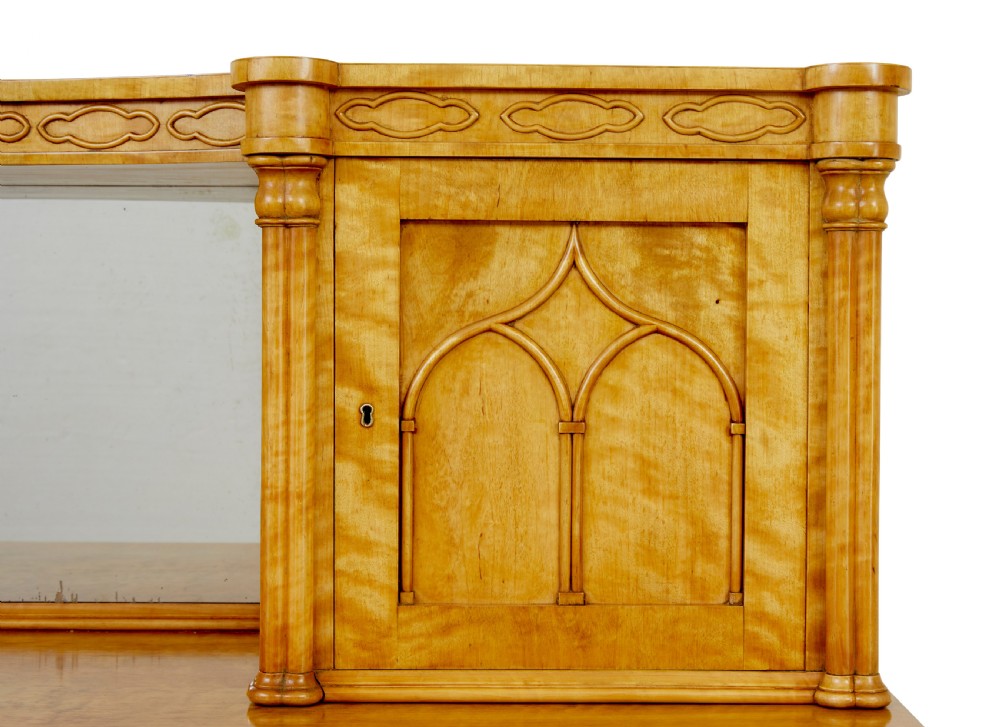 A mid-19th-century Swedish satin birch buffet sideboard featuring a lower three-door cabinet with carved petal applied mouldings and an upper tiered superstructure with Gothic arch cabinet doors. View IX