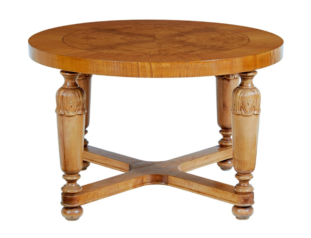 A low circular Art Deco coffee table crafted from light golden birch with an inlaid central panel and carved legs connected by an X-frame stretcher. View II