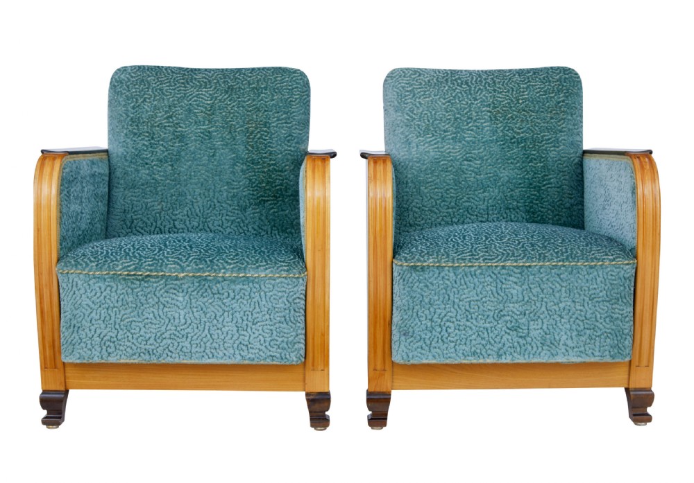 A pair of Swedish Art Deco armchairs featuring curved blonde wood arms, teal textured fabric upholstery, and dark block feet.