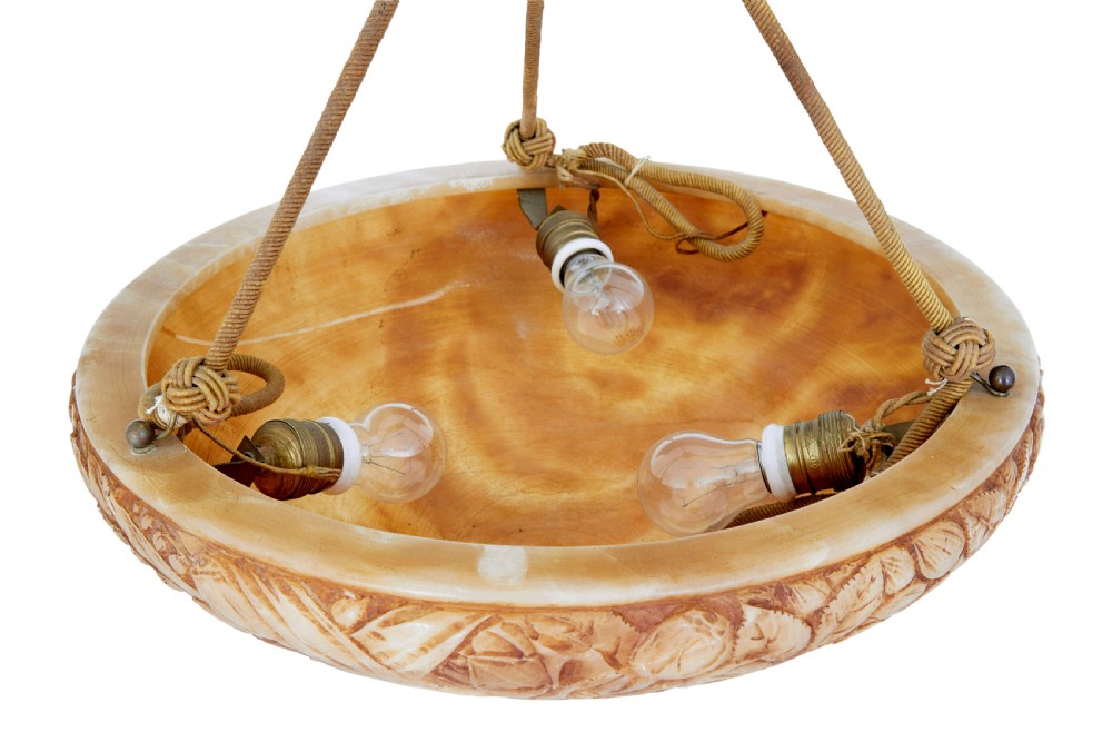 A carved warm amber alabaster ceiling bowl light suspended by three woven cords with a textured canopy. View V