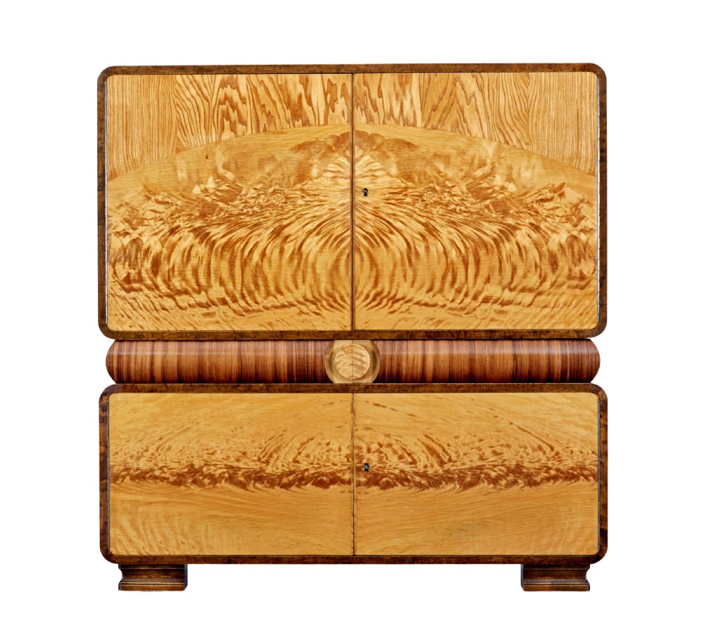 A Scandinavian Art Deco cabinet in blonde birch and elm veneer with two upper doors, a central reeded waist band, and two lower doors. View II