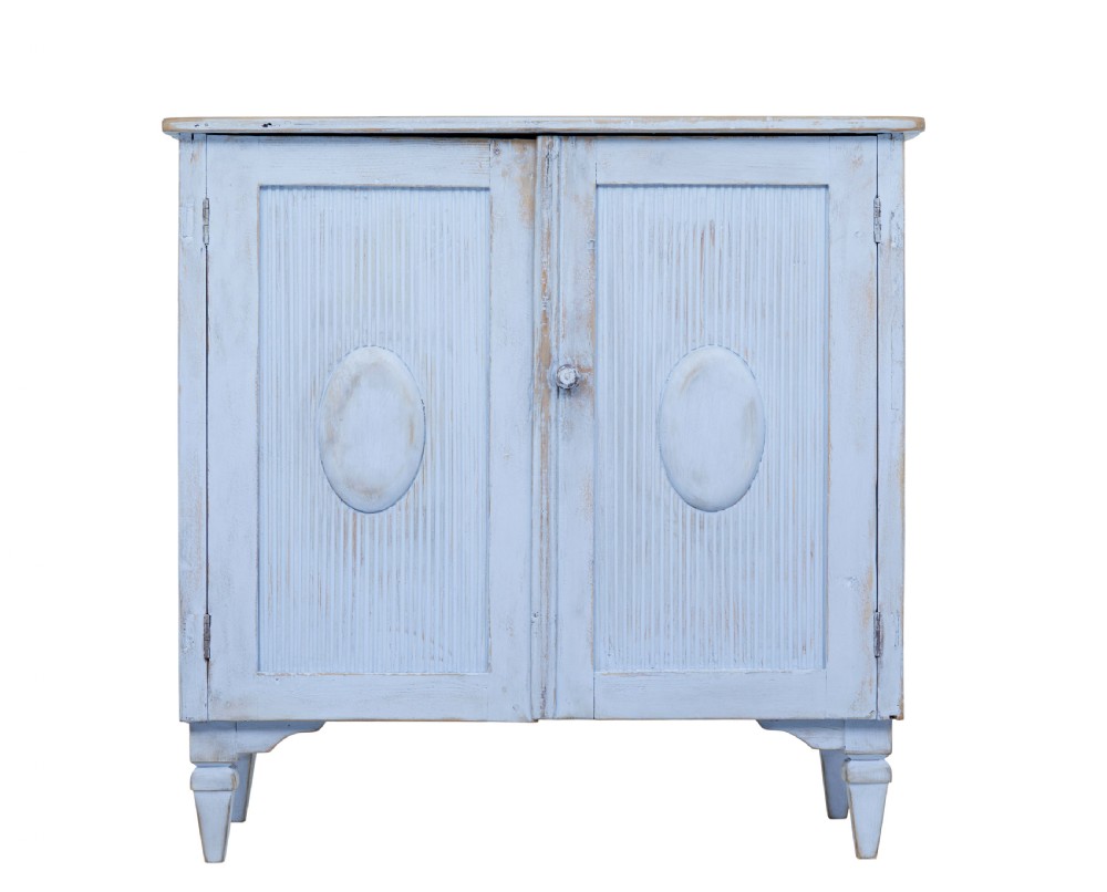 A 19th-century light blue painted pine two-door cupboard featuring reeded door panels with raised oval details and short turned feet. View IV