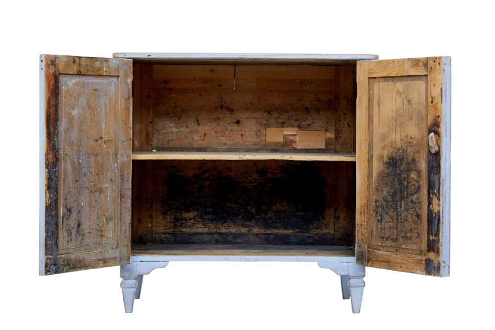 A 19th-century light blue painted pine two-door cupboard featuring reeded door panels with raised oval details and short turned feet. View V