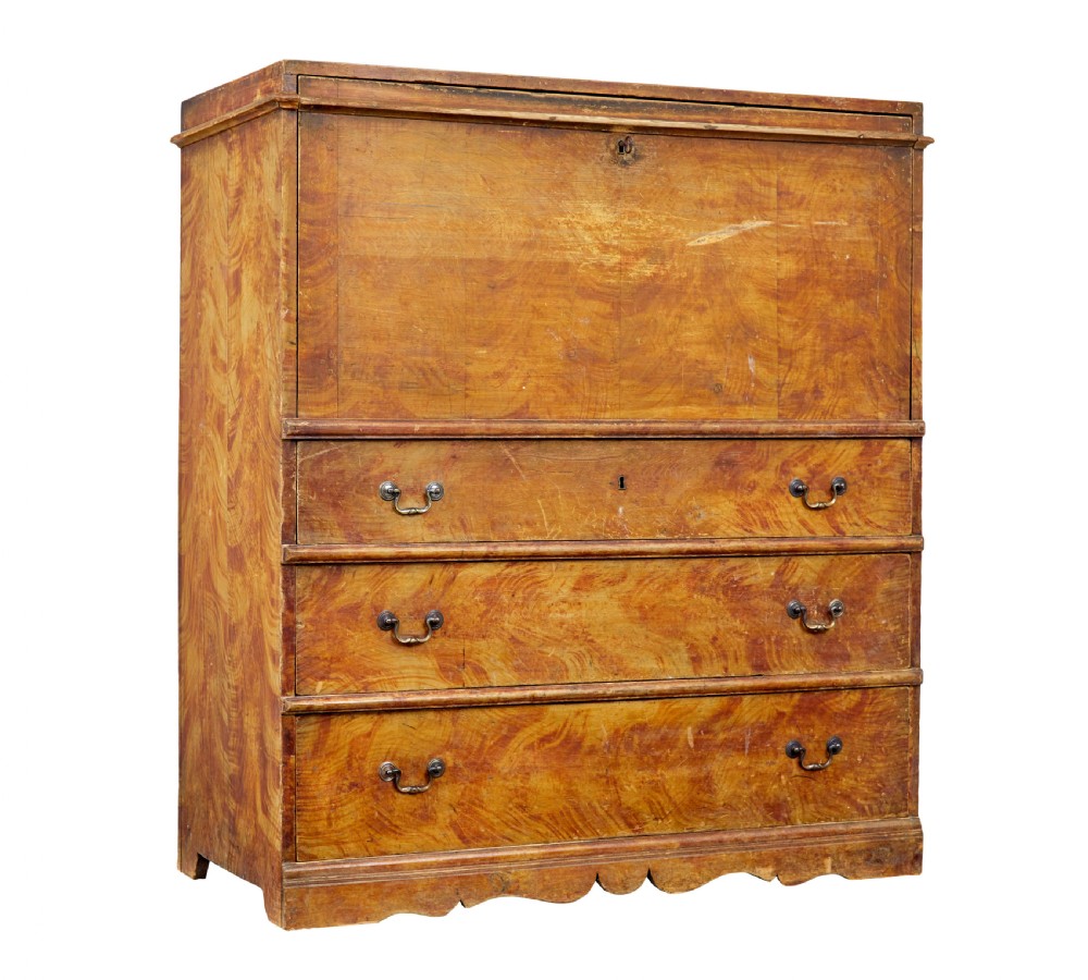 A 19th-century Swedish painted pine escritoire featuring a fall-front top section above three long drawers, finished in a faux-wood grain paint with brass drop handles and a scalloped plinth base.