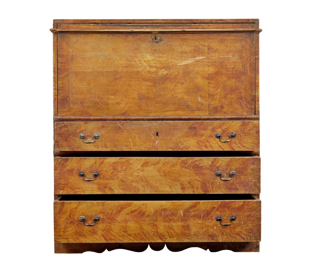 A 19th-century Swedish painted pine escritoire featuring a fall-front top section above three long drawers, finished in a faux-wood grain paint with brass drop handles and a scalloped plinth base. View III