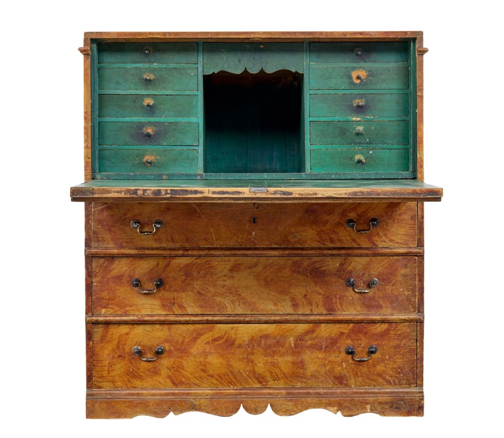 A 19th-century Swedish painted pine escritoire featuring a fall-front top section above three long drawers, finished in a faux-wood grain paint with brass drop handles and a scalloped plinth base. View IV