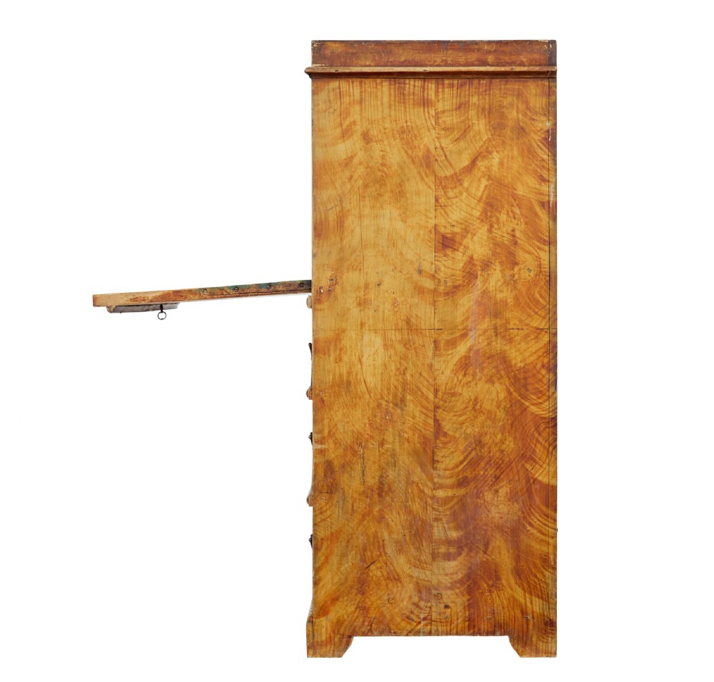A 19th-century Swedish painted pine escritoire featuring a fall-front top section above three long drawers, finished in a faux-wood grain paint with brass drop handles and a scalloped plinth base. View V