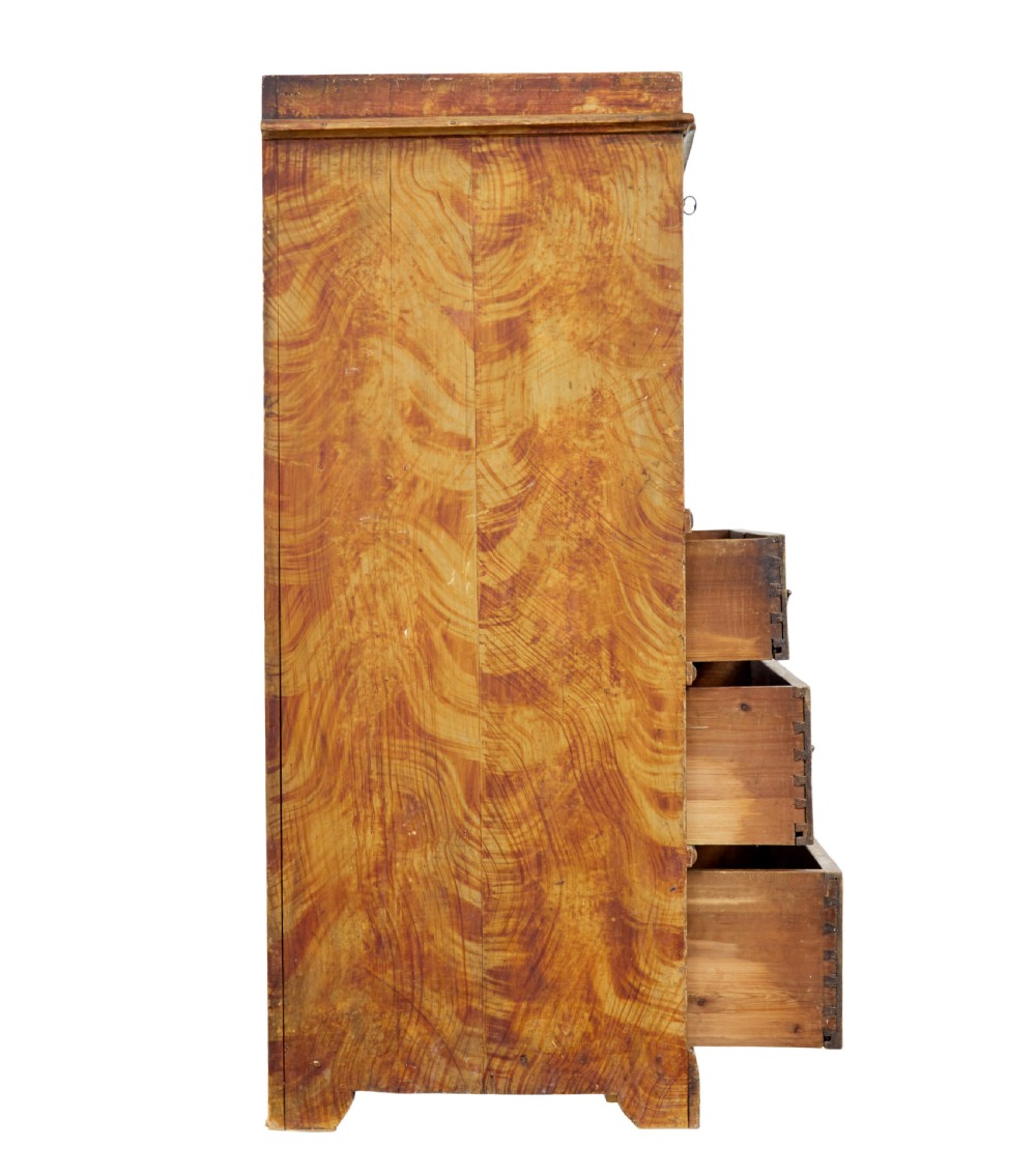 A 19th-century Swedish painted pine escritoire featuring a fall-front top section above three long drawers, finished in a faux-wood grain paint with brass drop handles and a scalloped plinth base. View VII
