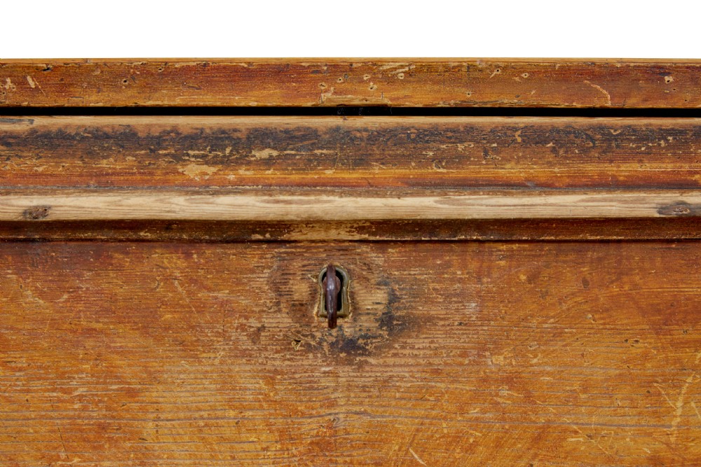A 19th-century Swedish painted pine escritoire featuring a fall-front top section above three long drawers, finished in a faux-wood grain paint with brass drop handles and a scalloped plinth base. View VIII