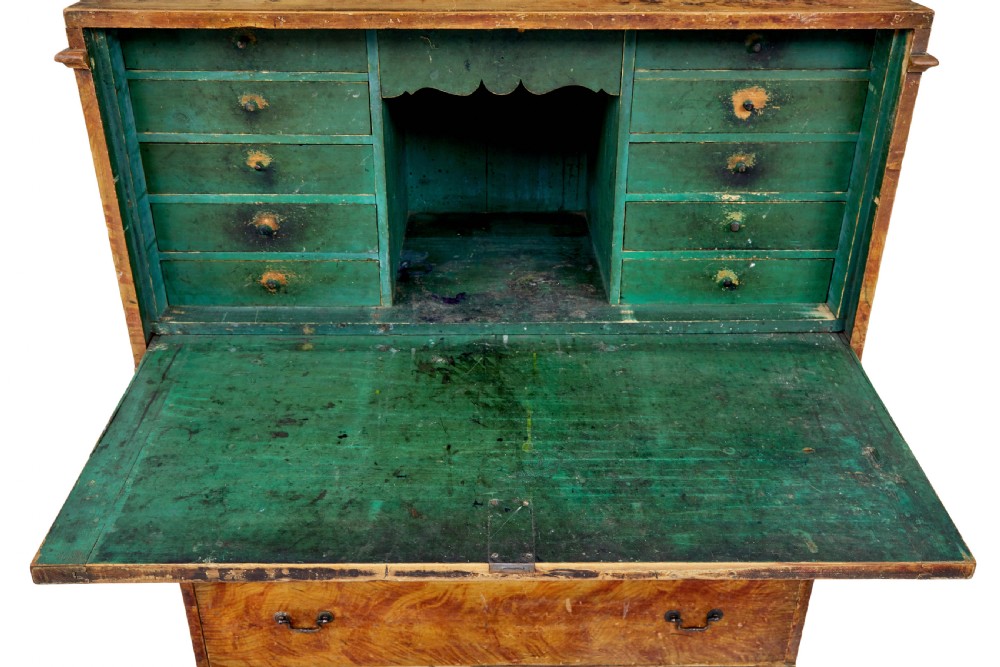 A 19th-century Swedish painted pine escritoire featuring a fall-front top section above three long drawers, finished in a faux-wood grain paint with brass drop handles and a scalloped plinth base. View XI