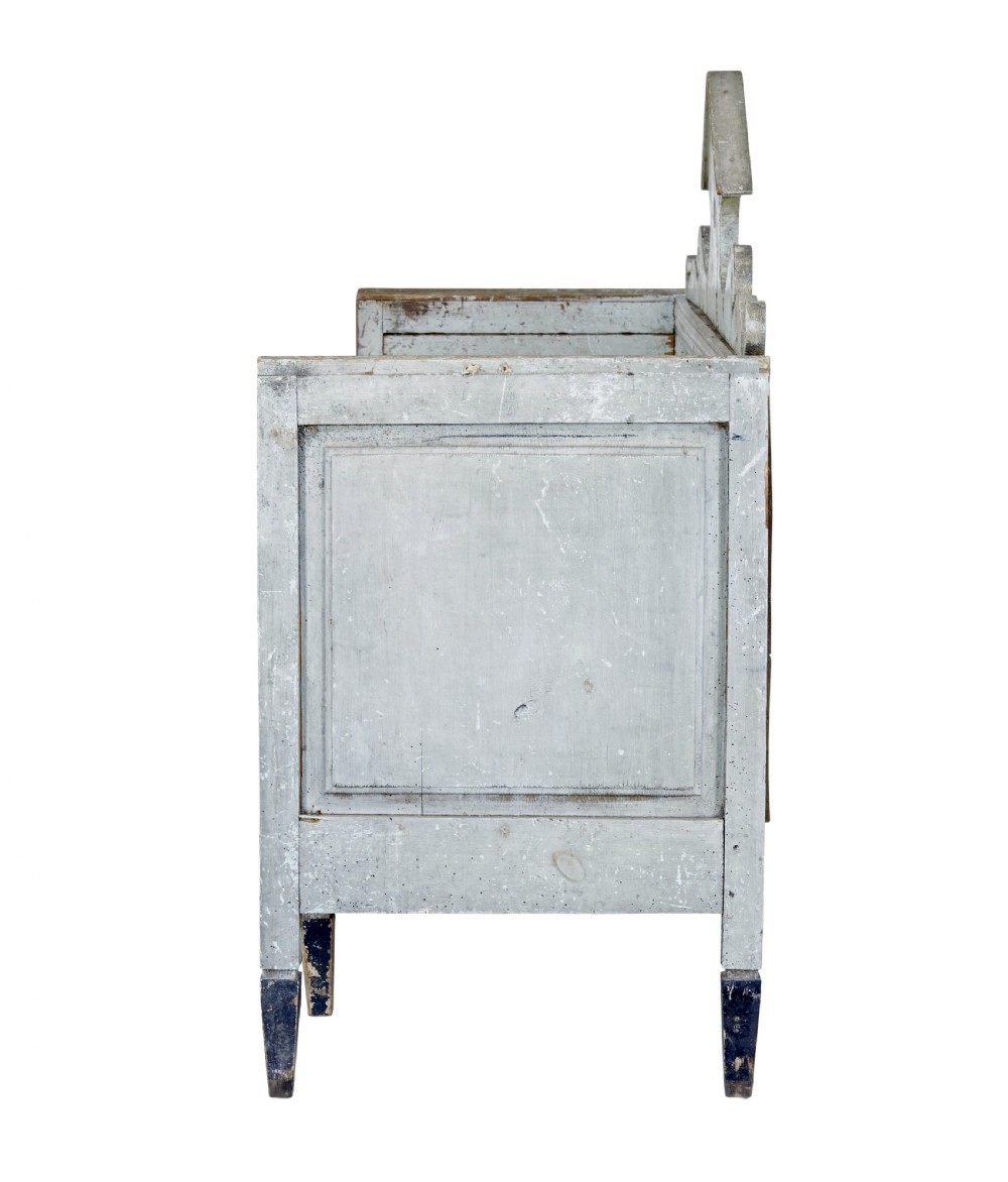 An early 19th-century Swedish Gustavian bench in distressed grey paint featuring a pedimented backrest and tapered legs. View III