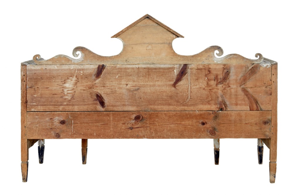 An early 19th-century Swedish Gustavian bench in distressed grey paint featuring a pedimented backrest and tapered legs. View V