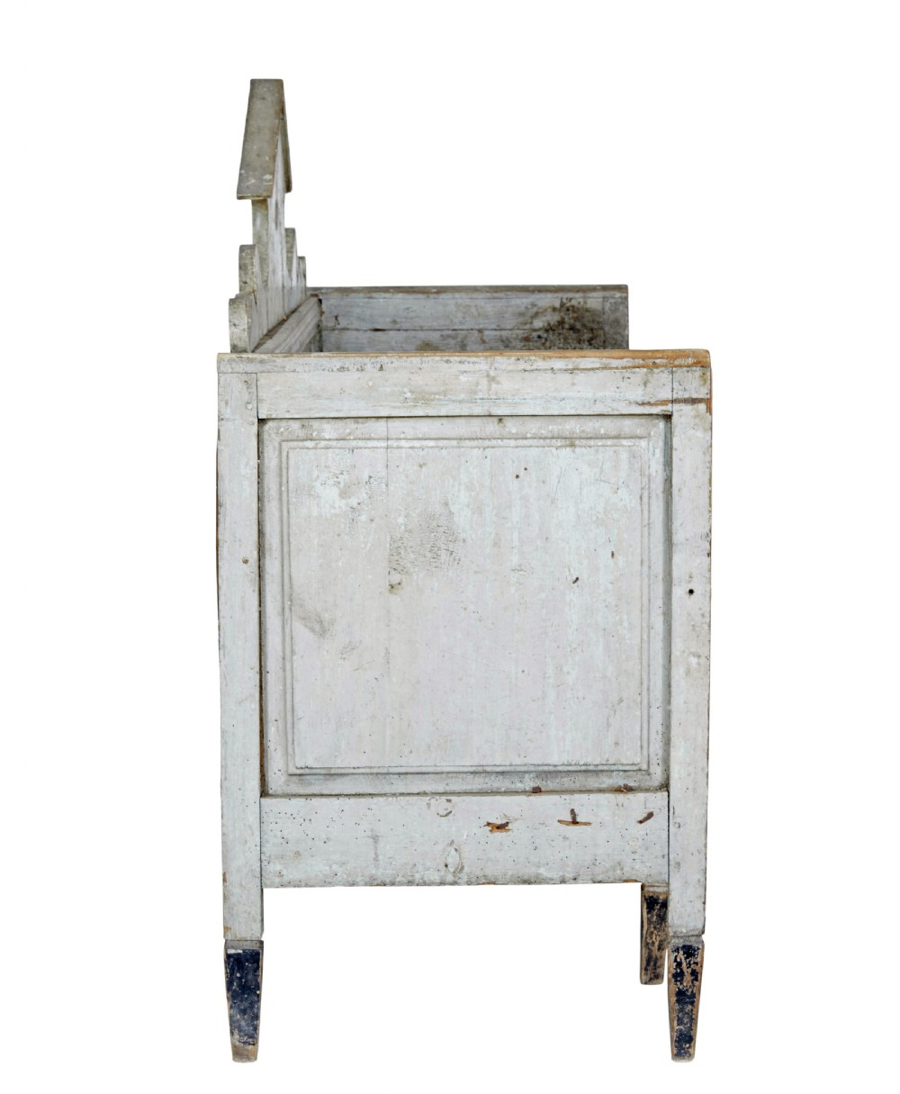 An early 19th-century Swedish Gustavian bench in distressed grey paint featuring a pedimented backrest and tapered legs. View VI