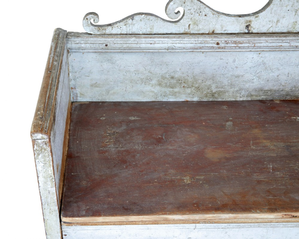 An early 19th-century Swedish Gustavian bench in distressed grey paint featuring a pedimented backrest and tapered legs. View X
