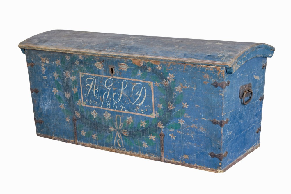 A nineteenth-century Swedish pine coffer painted in blue featuring hand-lettered initials AGSD dated 1854, floral wreath decoration, and wrought iron fittings. View V