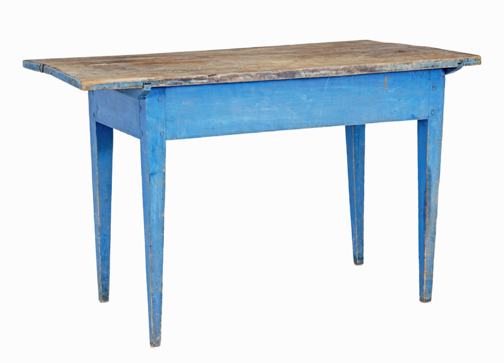 A 19th-century rustic side table featuring a blue painted apron and tapered legs with an unpainted natural pine plank top.
