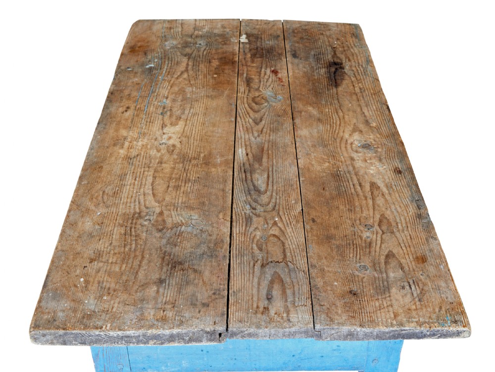 A 19th-century rustic side table featuring a blue painted apron and tapered legs with an unpainted natural pine plank top. View II