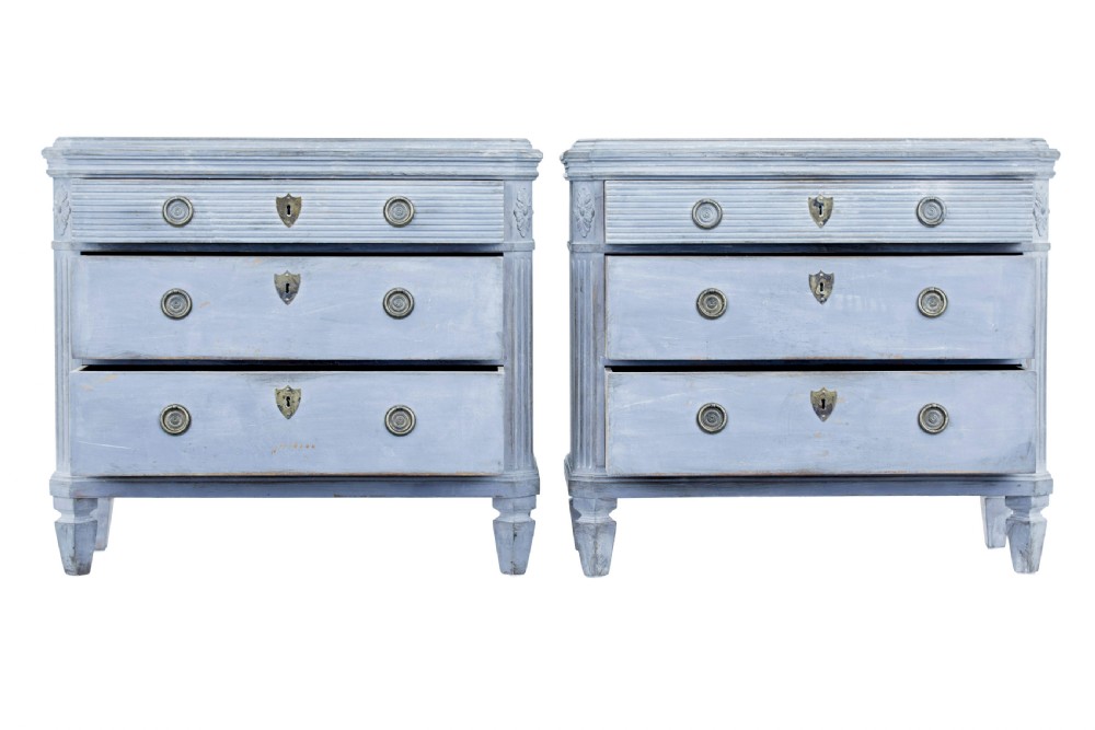 A pair of 19th-century light blue painted Swedish chests of drawers featuring three drawers, fluted sides, circular brass pull handles, and brass shield escutcheons. View II