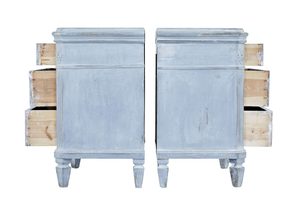 A pair of 19th-century light blue painted Swedish chests of drawers featuring three drawers, fluted sides, circular brass pull handles, and brass shield escutcheons. View III