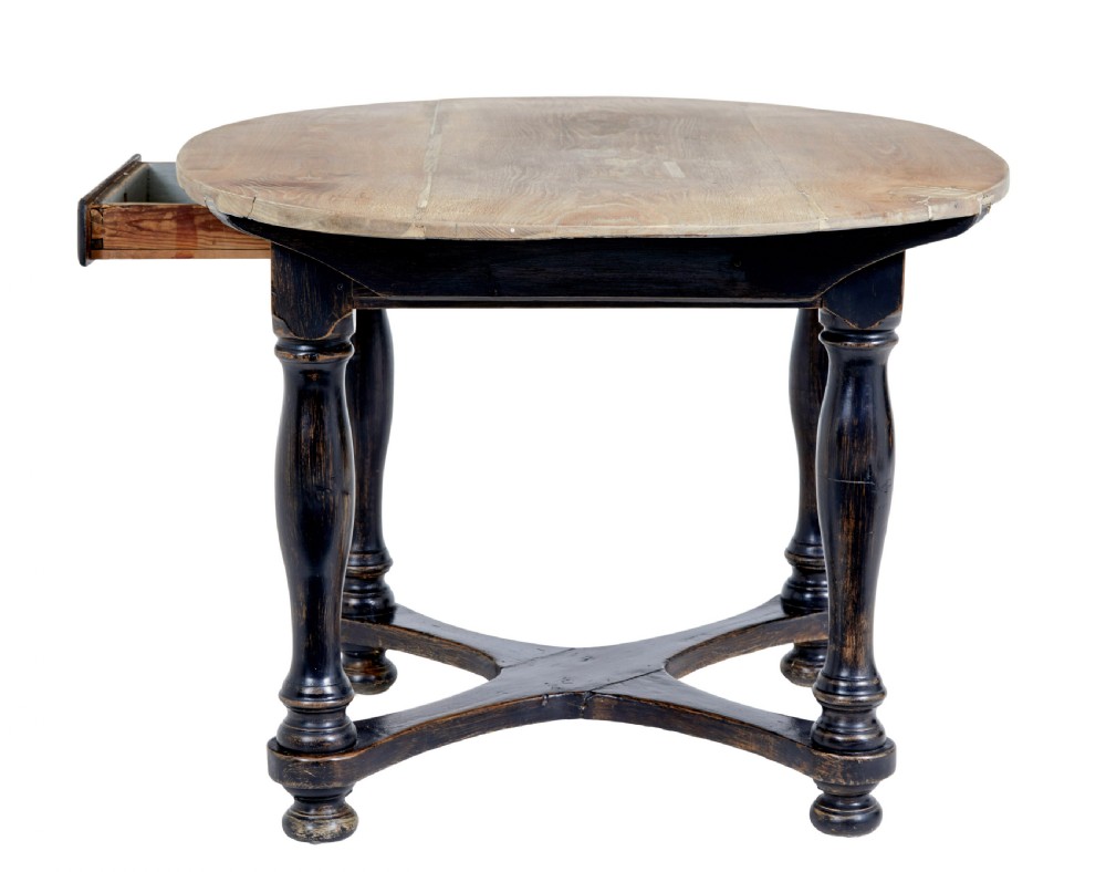 A rustic 19th-century circular occasional table featuring a natural wood top, a dark painted base with a single drawer, turned legs, and an X-shaped cross-stretcher. View III