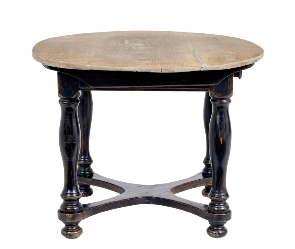 A rustic 19th-century circular occasional table featuring a natural wood top, a dark painted base with a single drawer, turned legs, and an X-shaped cross-stretcher. View V