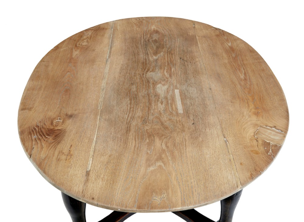A rustic 19th-century circular occasional table featuring a natural wood top, a dark painted base with a single drawer, turned legs, and an X-shaped cross-stretcher. View VI