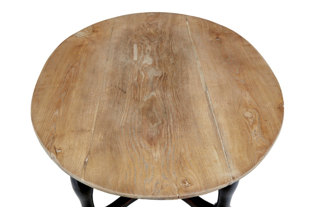 A rustic 19th-century circular occasional table featuring a natural wood top, a dark painted base with a single drawer, turned legs, and an X-shaped cross-stretcher. View VII